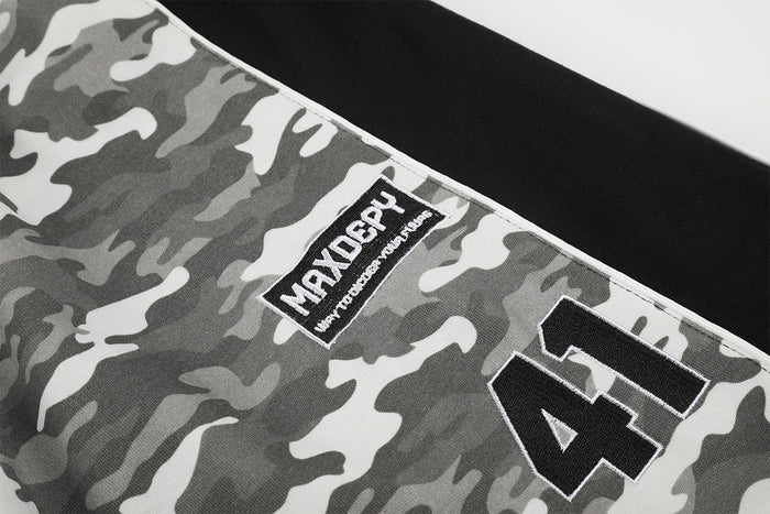 Close-up of the gray camouflage pants showing the sewn label and black number 41 patch
