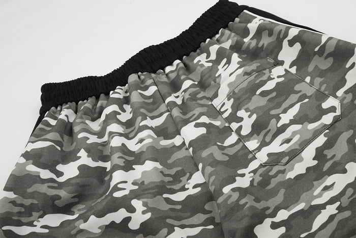 Close-up of a rectangular back pocket on gray camouflage sweatpants beside the black waistband