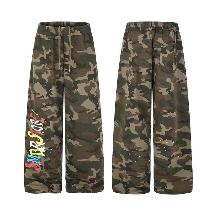 Camo wide-leg sweatpants shown front and back, with colorful graffiti lettering and paint splatters