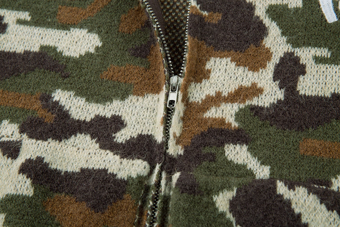 Close-up of the front zipper on an olive and brown camouflage knit hoodie