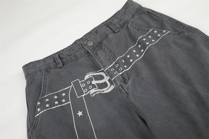 Close-up of gray cargo pants waist with printed star belt graphic and front pocket seam