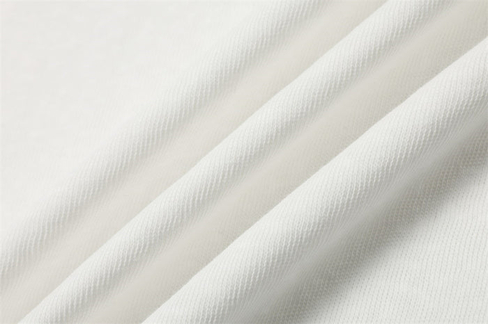 White knit fabric close-up with soft ribbed texture