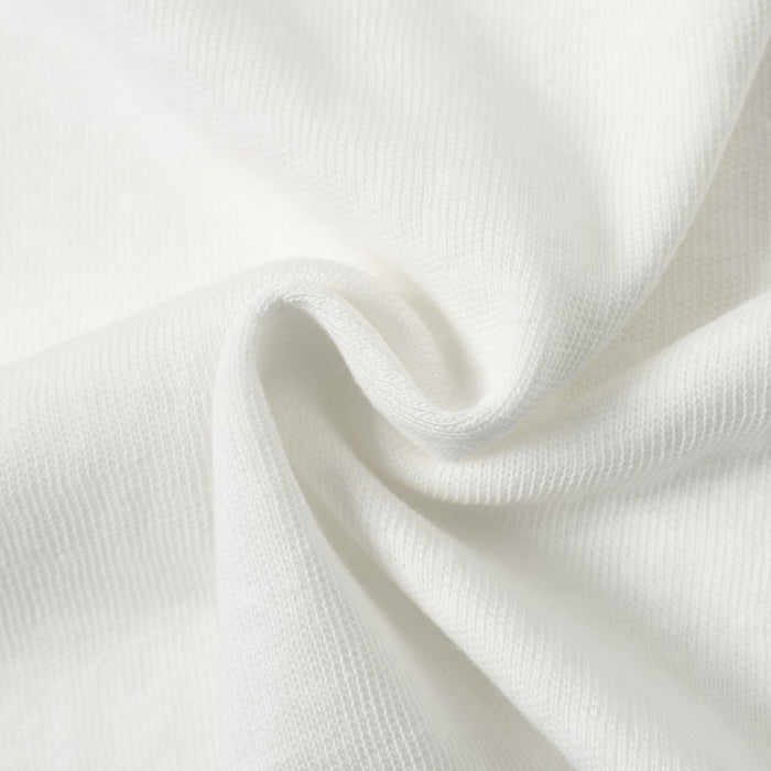 White fabric close-up with folded drape and fine texture