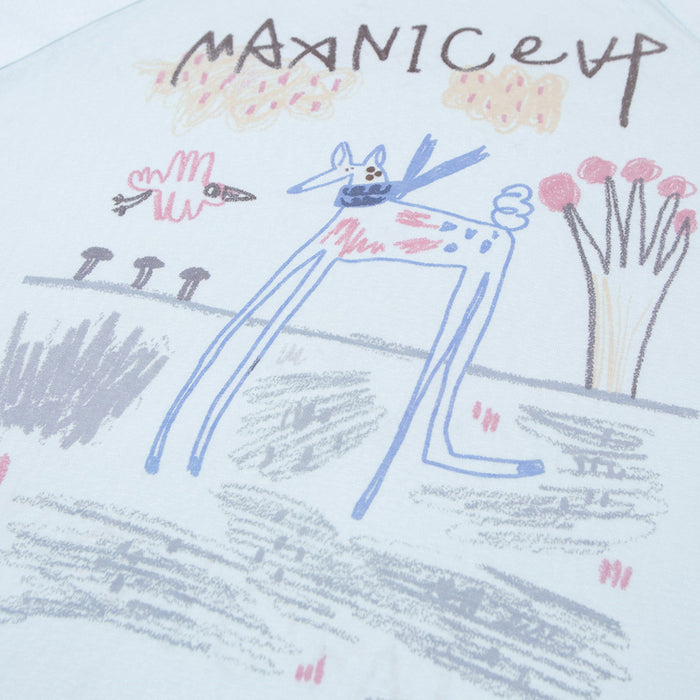 Close-up of the light blue shirt’s doodle graphic featuring a long-legged animal, flowers, and sketchy landscape