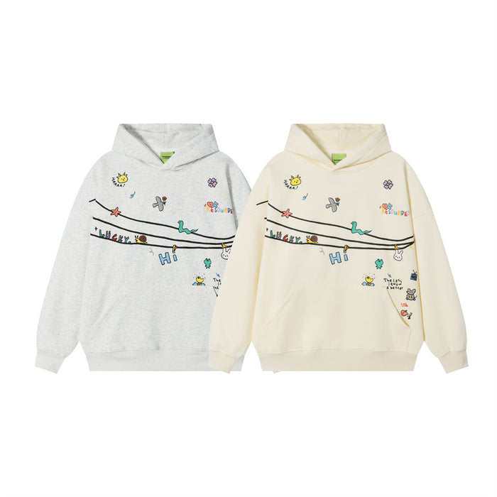 Front view of gray and cream oversized pullover hoodies with colorful whimsical doodle graphics