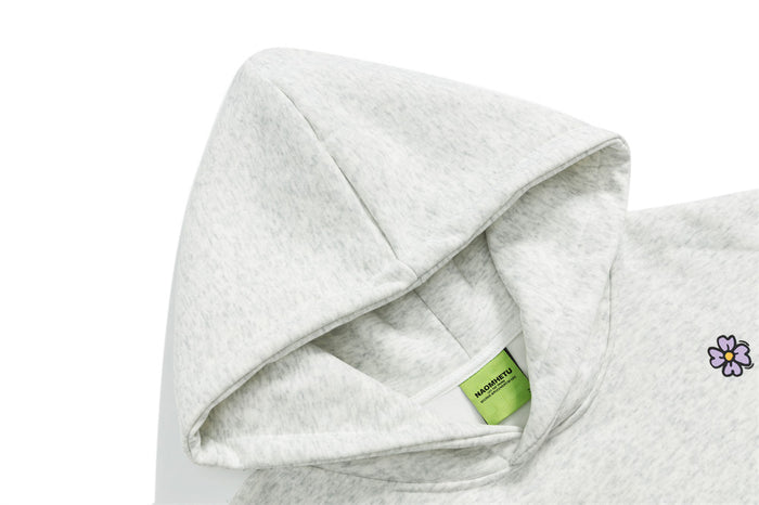 Close-up of the gray hoodie’s layered hood, soft inner lining, and green neck label