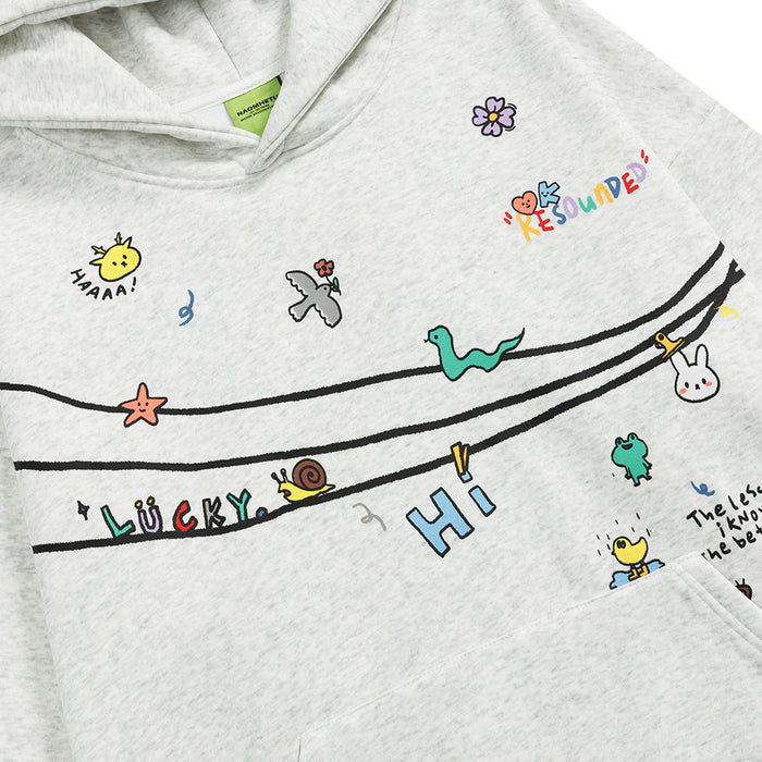 Close-up of the gray hoodie chest showing colorful doodles, curved black lines, and playful lettering