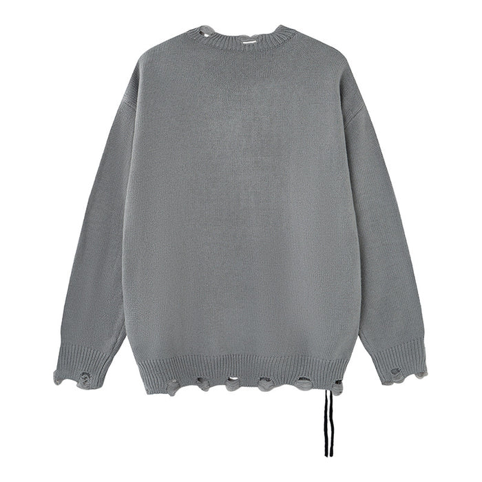 Gray distressed knit sweater shown from the back with a plain knit design, ragged hem, and loose black threads