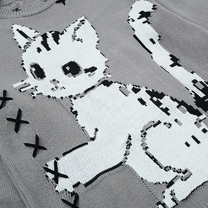 Close-up of white cat graphic with black details on the gray knit sweater front and stitched X accents