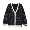 Oversized V-neck knit cardigan with white cat outline embroidery, contrast cream trim, and distressed hem in black colorway