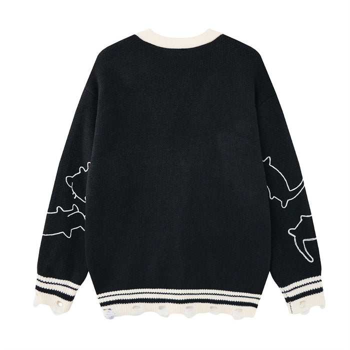 Black knit cardigan shown from the back with cream collar, striped hem, and cat outlines on the sleeves