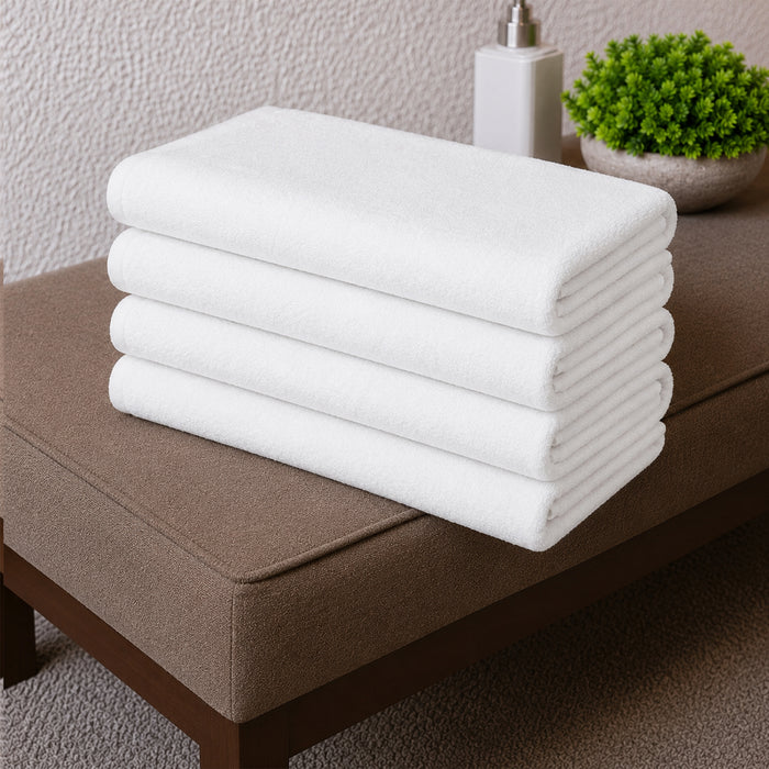 White cotton towel set folded on a white background
