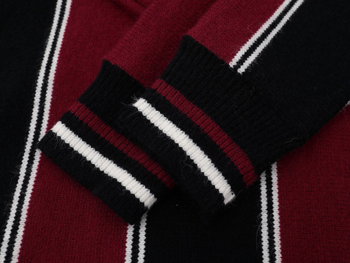 Close-up of burgundy and black knit stripes with white trim and fuzzy texture