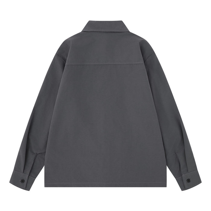 Gray long sleeve button-up racing shirt shown from the back with a yoke seam and adjustable cuff tabs