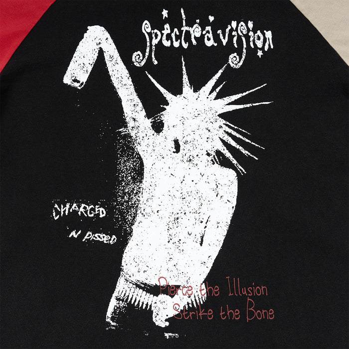 Close-up of the shirt front showing a distressed white raised-arm figure graphic with decorative text on black fabric