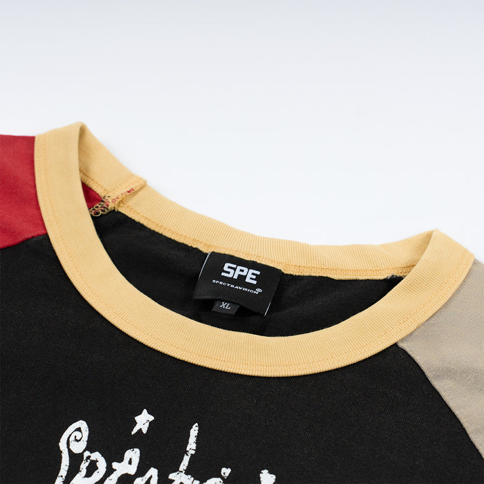 Close-up of the beige ribbed crew neckline, shoulder colorblocking, inner label, and partial white front graphic