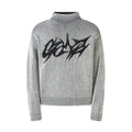 Black and white ribbed knit sweater with bold lightning script graphic on the chest and high mock neck collar