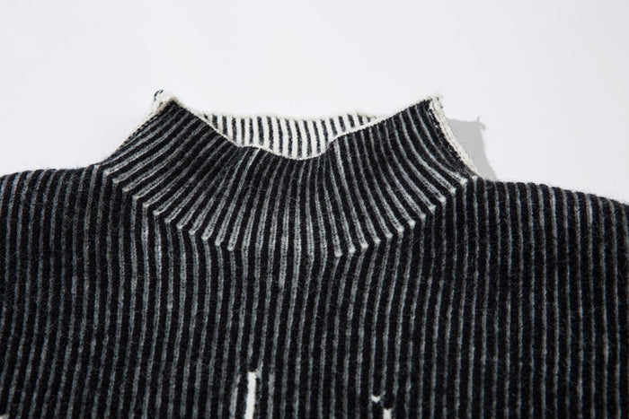 Close-up of black ribbed knit turtleneck with white striped inside collar
