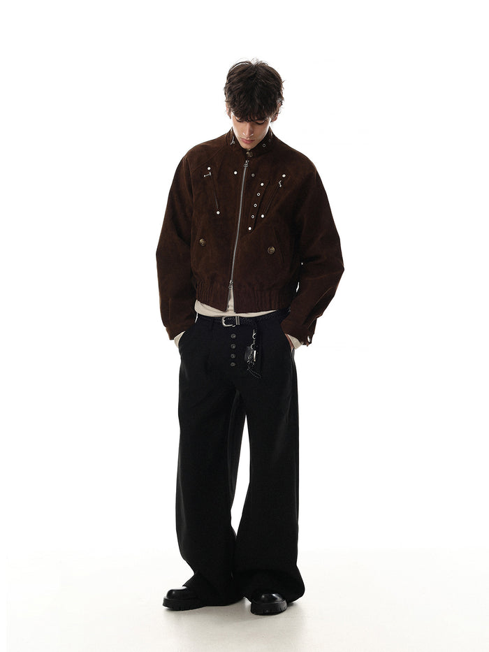 Full-body model wearing a brown cropped suede bomber jacket with a high collar and metal details