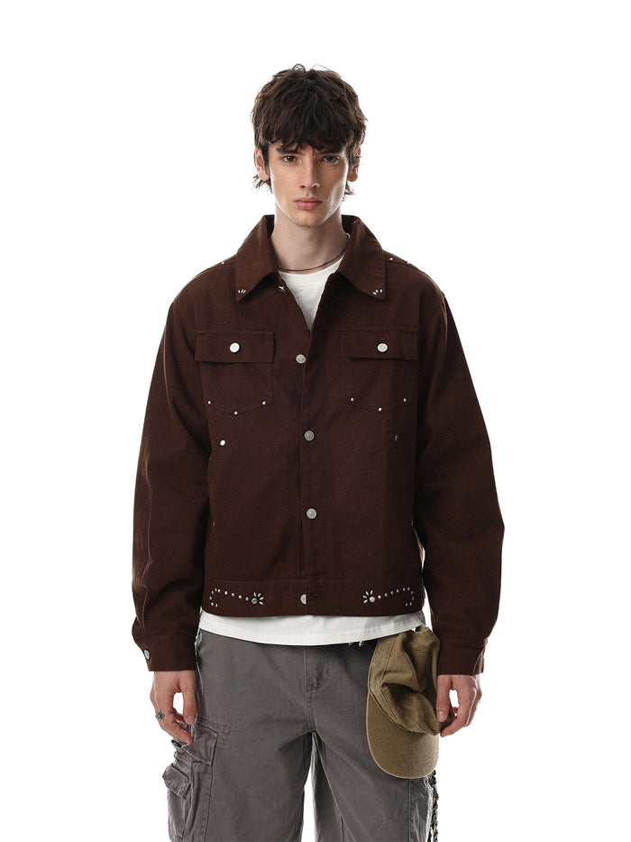 Front view of a brown suede jacket with snap buttons, chest pockets, and decorative metal studs