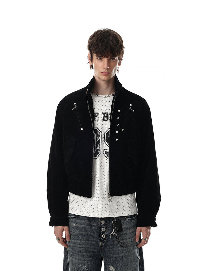 Front view of a black cropped suede bomber jacket layered over a graphic shirt