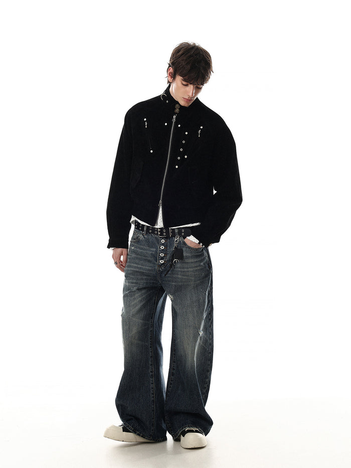 Full-body view of a model wearing a black cropped suede bomber jacket with silver hardware