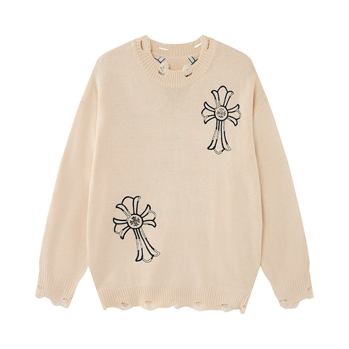 Cream knit sweater with two black embroidered cross motifs and visibly distressed ribbed hem and cuffs