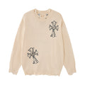 Cream knit sweater with two black embroidered cross motifs and visibly distressed ribbed hem and cuffs
