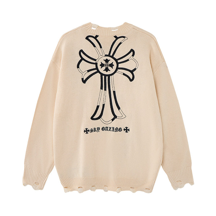 Cream distressed knit sweater with a large black embroidered cross, decorative text and frayed edges