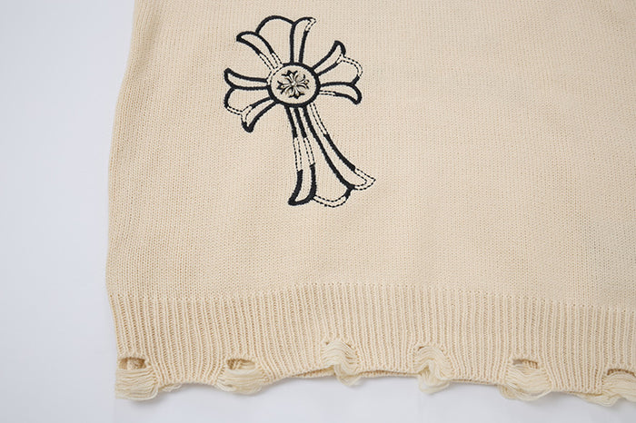 Cream sweater lower section with embroidered cross motif above a ribbed, looped distressed hem