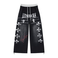 Black wide-leg sweatpants with gray faux waistband, white distressed lettering and cross graphics, red script, and drawcord