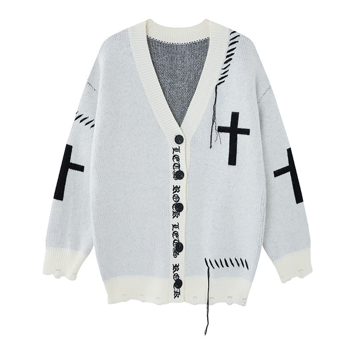 White distressed knit cardigan shown front-facing with cross motifs, V-neck, black buttons, gothic lettering, and loose threads
