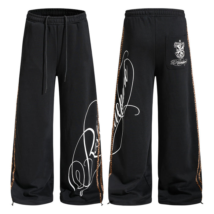 Black wide-leg sweatpants with leopard side tape and white cursive script graphic print, front and back view