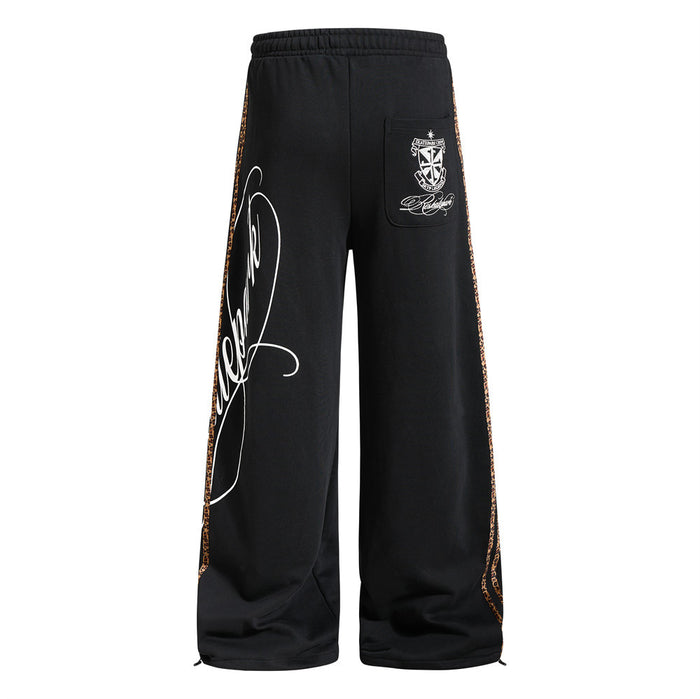 Back view of black wide-leg sweatpants with rear patch pocket and leopard side tape