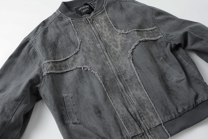 Gray washed denim bomber jacket laid flat, showing frayed curved seams, zipper front, and angled pockets