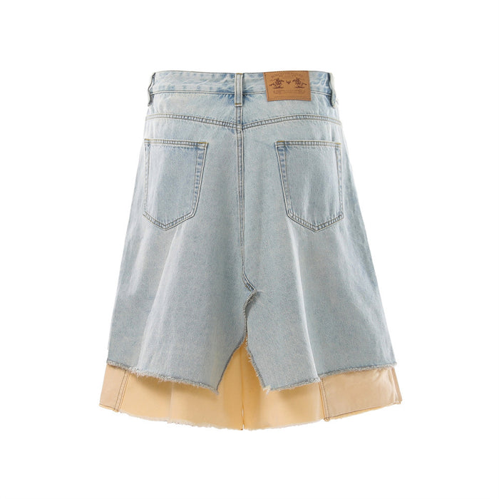 Back view of light blue distressed denim skirt shorts with layered beige hem and patch pockets