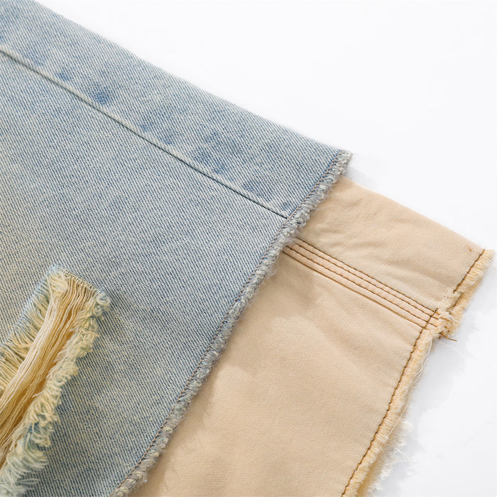 Close-up of frayed hem showing light blue denim outer layer over beige underlayer