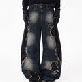 Men's distressed patchwork wide-leg jeans in washed indigo denim with large rips and frayed appliqués