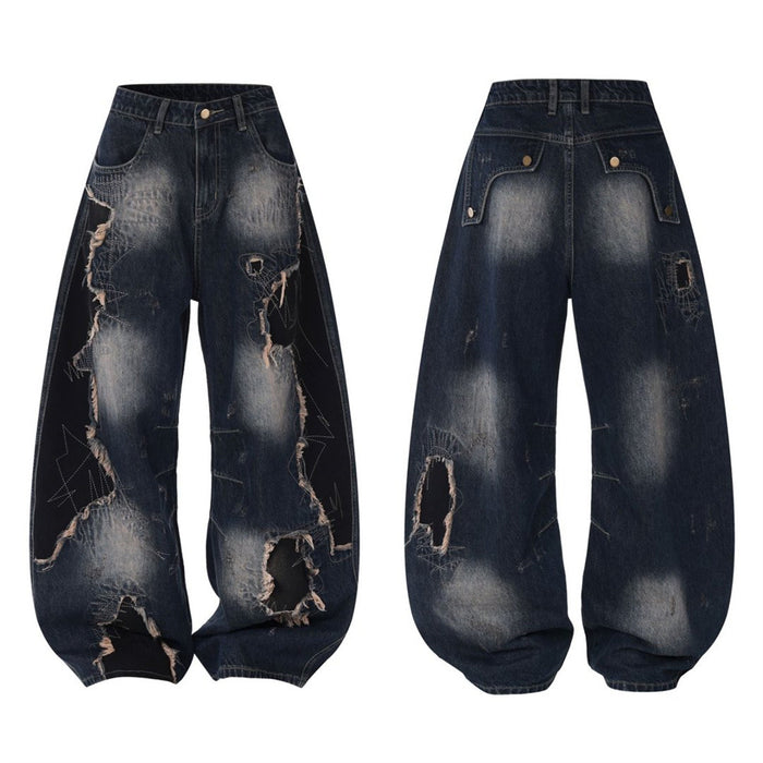 Dark blue wide-leg jeans shown front and back with washed fading, patchwork panels, and extensive ripped detailing