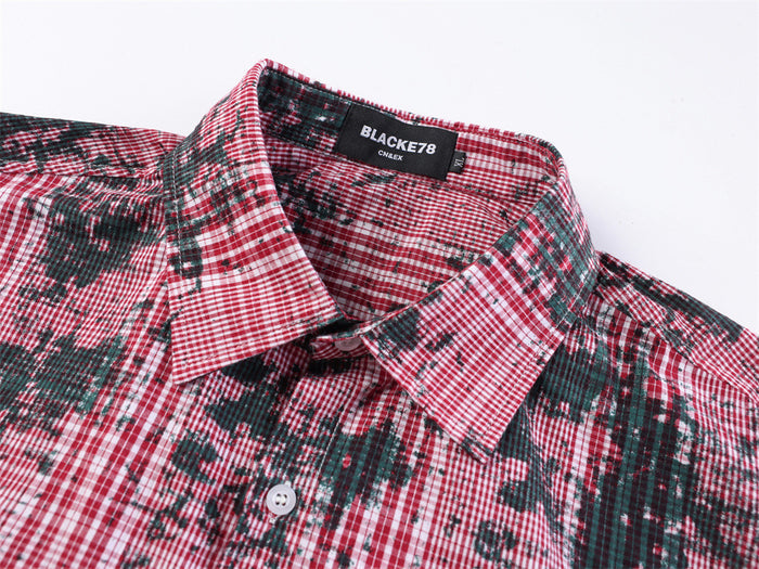 Red plaid shirt collar and neck label close-up with button placket visible