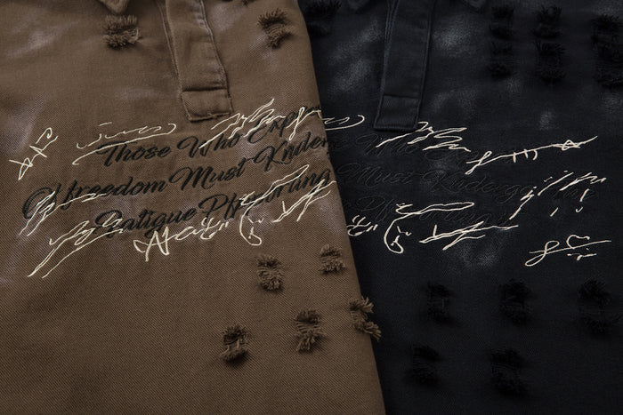 Close-up of brown and black polo shirts showing contrasting script chest embroidery and raised frayed fabric details