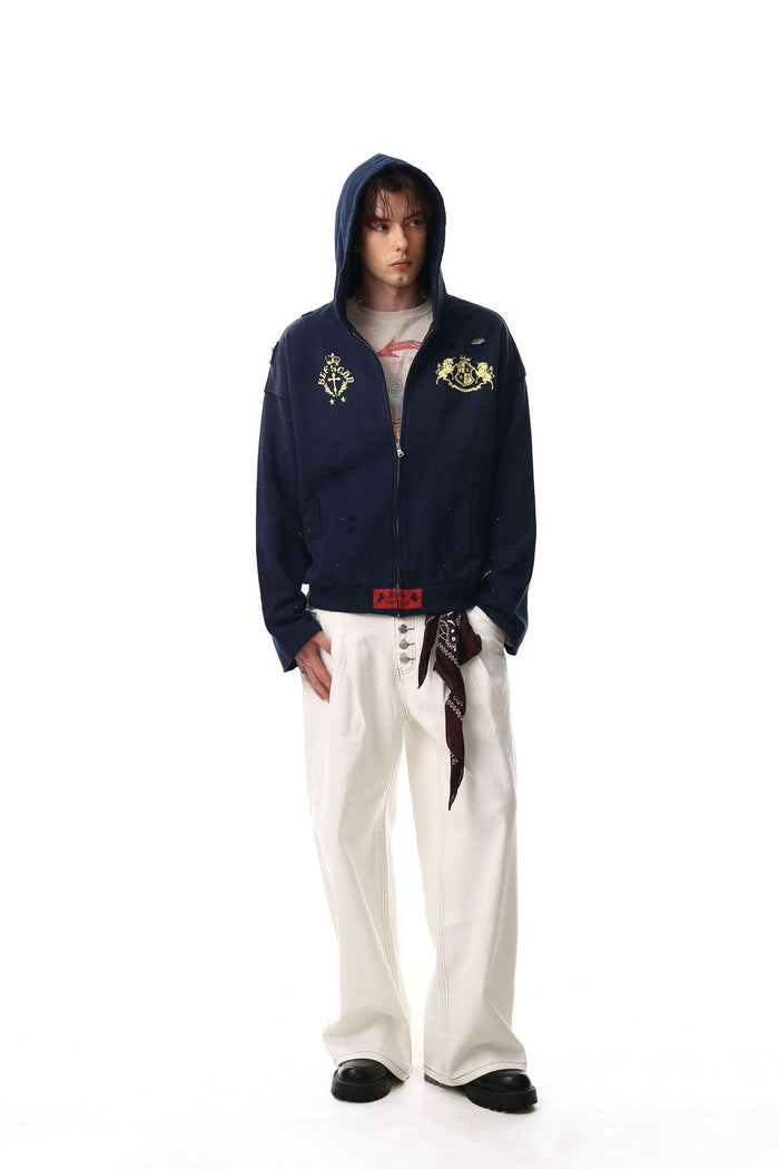 Full-length front view of a navy zip-up hoodie worn with the hood up and gold chest graphics
