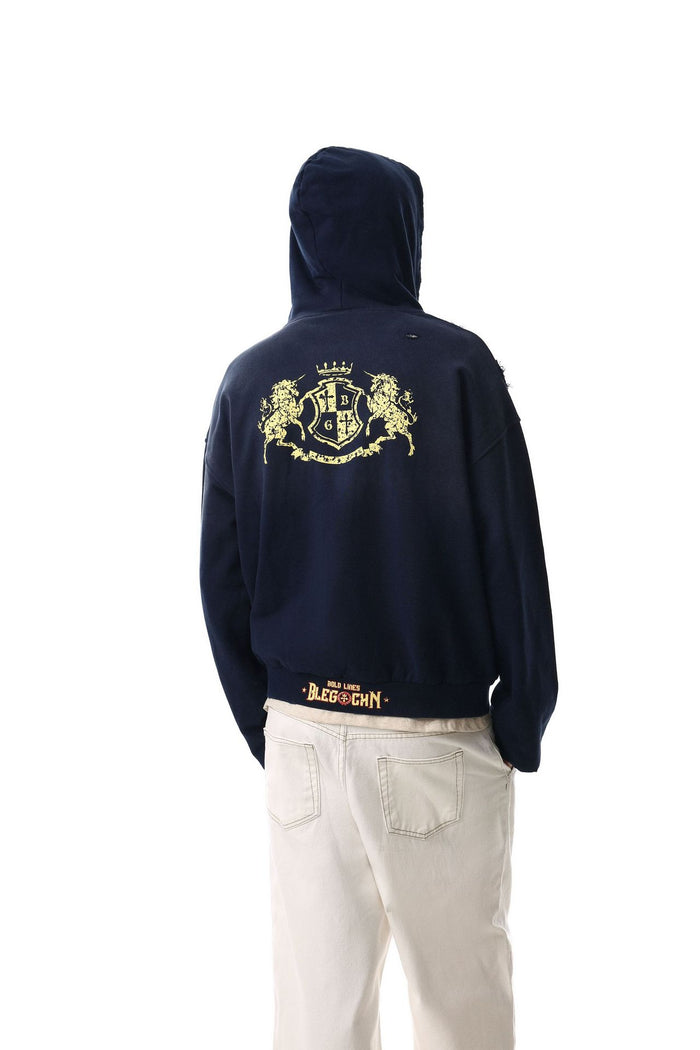 Back view of a navy hooded jacket showing a large gold heraldic crest across the shoulders