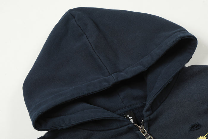 Close-up of the navy hoodie showing the textured hood, lining and metal zipper pull