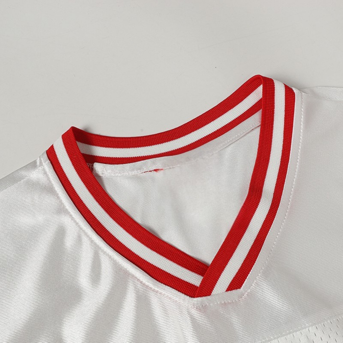 White football jersey with red striped V-neck collar and textured fabric, styled for sporty streetwear
