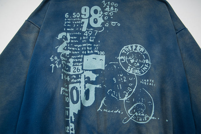 Close-up of the hoodie back featuring a large distressed pale blue collage of numbers, text, and circular sketches