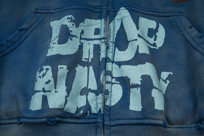 Close-up of the front pouch pocket with large distressed pale blue lettering split by the zipper