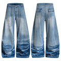 Front and back view of Omirad vintage wash super baggy wide-leg jeans with embroidered script graphics and stacked hem