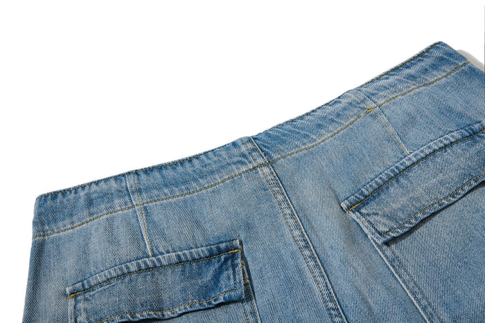 Close-up of jeans back pocket and upper yoke stitching in light wash denim
