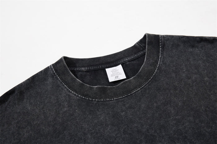 Close-up of the black acid wash T-shirt crew neck and collar label